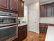 Modern kitchen equipped with stainless steel appliances, dark wood cabinets, oven and hardwood floors at 2785 Disney Pl, Indian Land, SC 29707