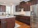 Kitchen with stainless steel appliances, an island, and dark wood cabinets at 2785 Disney Pl, Indian Land, SC 29707