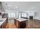 Open concept kitchen featuring a large center island, stainless appliances, and hardwood flooring at 2785 Disney Pl, Indian Land, SC 29707