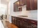 Kitchen featuring dark wood cabinets, stainless steel appliances, and a gas cooktop on white countertops at 2785 Disney Pl, Indian Land, SC 29707