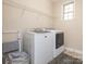 Functional laundry room with modern washer and dryer units and shelving at 2785 Disney Pl, Indian Land, SC 29707