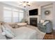 Cozy living room with a fireplace, large windows, and comfortable seating at 2785 Disney Pl, Indian Land, SC 29707