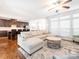 Bright living room with hardwood floors, a large sectional sofa, and an open floorplan to the kitchen at 2785 Disney Pl, Indian Land, SC 29707