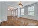 Elegant living room featuring hardwood floors, fresh paint, and decorative lighting at 2785 Disney Pl, Indian Land, SC 29707