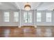 Bright living room boasting hardwood floors, white trim, french doors, and a stunning chandelier at 2785 Disney Pl, Indian Land, SC 29707