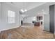 Open concept living space with hardwood floors connecting the dining, living, and kitchen areas at 2785 Disney Pl, Indian Land, SC 29707