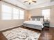 Main bedroom boasts a large bed, side tables, and tray ceilings at 2785 Disney Pl, Indian Land, SC 29707