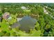 A tranquil aerial view of a pond surrounded by lush greenery and walking paths at 2785 Disney Pl, Indian Land, SC 29707