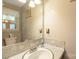 Neutral bathroom featuring a large mirror, window, and updated fixtures and countertop at 310 Yarbro Rd, Kings Mountain, NC 28086