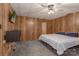 Cozy bedroom featuring wood paneling, soft carpet, TV and a comfortable bed with blue pillows at 310 Yarbro Rd, Kings Mountain, NC 28086