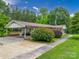 Low angle front view of a well-maintained single-story home with mature landscaping and an attached carport at 310 Yarbro Rd, Kings Mountain, NC 28086