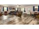 Open living room features laminate flooring, ample seating, and a whitewashed brick wall at 310 Yarbro Rd, Kings Mountain, NC 28086