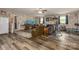 Spacious living room with laminate flooring, painted brick, an entertainment area, and workout equipment at 310 Yarbro Rd, Kings Mountain, NC 28086