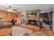 Inviting living room features brick fireplace, hardwood floors, wood paneling, and open to kitchen at 310 Yarbro Rd, Kings Mountain, NC 28086
