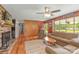 Cozy living room featuring a fireplace, hardwood floors, wood paneling, and lots of natural light at 310 Yarbro Rd, Kings Mountain, NC 28086