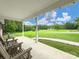 Spacious covered porch with seating overlooking a well-manicured lawn and scenic view at 310 Yarbro Rd, Kings Mountain, NC 28086