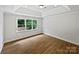 Well-lit bedroom features tray ceilings and a large window with views of the yard at 3104 Doncaster Dr, Rock Hill, SC 29732