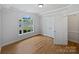 Unfurnished bedroom with a decorative window, wood floors, and plenty of closet space at 3104 Doncaster Dr, Rock Hill, SC 29732