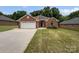 Charming brick home featuring a two-car garage and a well-manicured lawn at 3104 Doncaster Dr, Rock Hill, SC 29732