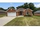 Charming brick home with a well-manicured lawn, attached garage, and inviting curb appeal at 3104 Doncaster Dr, Rock Hill, SC 29732