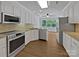 Clean kitchen featuring stainless appliances, stone countertops, and wood floors at 3104 Doncaster Dr, Rock Hill, SC 29732