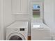 Functional laundry room with modern washer and dryer, built-in storage, and natural light at 3104 Doncaster Dr, Rock Hill, SC 29732