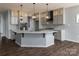 Bright kitchen featuring gray cabinets, stainless appliances and a unique island with stylish pendant lights at 3224 Ashwood Park Dr # 295, Belmont, NC 28012