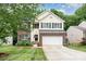 Charming two-story home with a well-manicured lawn and a two-car garage at 3236 Wicklow Ln, Clover, SC 29710