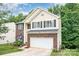 View of the home showcasing its brick and siding facade, two-car garage, and manicured lawn at 3236 Wicklow Ln, Clover, SC 29710