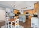 Open-concept kitchen featuring stainless steel appliances and a breakfast bar seating area at 3236 Wicklow Ln, Clover, SC 29710