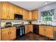 Kitchen area with wood cabinetry, dark countertops, and modern appliances at 3236 Wicklow Ln, Clover, SC 29710