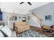 Spacious living room with hardwood floors, a dining area, and an open staircase at 3236 Wicklow Ln, Clover, SC 29710