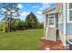 Home's backyard features a well-maintained lawn with a screened porch and landscaping at 332 Canvasback Rd, Mooresville, NC 28117