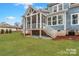 Wide backyard showing a well-manicured lawn and a screened in porch with outdoor access at 332 Canvasback Rd, Mooresville, NC 28117