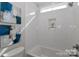 Modern bathroom with white subway tile, a built-in niche, and a bathtub at 332 Canvasback Rd, Mooresville, NC 28117