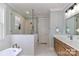 Bright new bathroom features a soaking tub, glass shower door, and warm wood cabinets at 332 Canvasback Rd, Mooresville, NC 28117