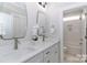 Elegant bathroom featuring double sinks, white countertops, and stylish mirrors at 332 Canvasback Rd, Mooresville, NC 28117