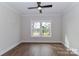 Neutral bedroom with hardwood floors, crown molding, and lots of light at 332 Canvasback Rd, Mooresville, NC 28117