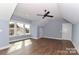 Airy bedroom showcasing large windows, hardwood floors and modern ceiling fan at 332 Canvasback Rd, Mooresville, NC 28117