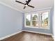 A bedroom features a ceiling fan, hardwood floors, and a large window at 332 Canvasback Rd, Mooresville, NC 28117
