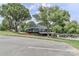 Clubhouse with a two-story design, golf carts, ample parking, and mature trees at 332 Canvasback Rd, Mooresville, NC 28117