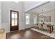 A dining room showcasing wainscoting, hardwood floors, and a stylish chandelier at 332 Canvasback Rd, Mooresville, NC 28117