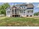 Exterior rear view of house with a screened porch and staircase to the yard at 332 Canvasback Rd, Mooresville, NC 28117