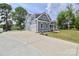 Two-story home featuring a side-entry garage, blue siding, white trim and a large driveway at 332 Canvasback Rd, Mooresville, NC 28117