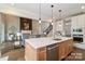 Open-concept kitchen with a large island, modern appliances, and seamless flow to the living and dining areas at 332 Canvasback Rd, Mooresville, NC 28117