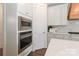 Built in microwave and oven with white cabinets, quartz countertops, and a gas range cooktop at 332 Canvasback Rd, Mooresville, NC 28117