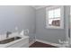 A laundry room featuring a sink, plumbing for a washer and dryer, and a window at 332 Canvasback Rd, Mooresville, NC 28117