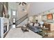Open-concept living space with fireplace, staircase, hardwood floors, and access to the kitchen at 332 Canvasback Rd, Mooresville, NC 28117