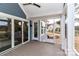 Relax on the covered patio with a ceiling fan, sliding glass doors, and access to a screened-in porch at 332 Canvasback Rd, Mooresville, NC 28117