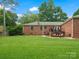 Large grassy backyard featuring a patio with outdoor furniture and a brick house exterior at 3367 Tanglewood Dr, Rock Hill, SC 29732